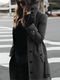 Stylish long women's coat with a high collar and elegant bow belt