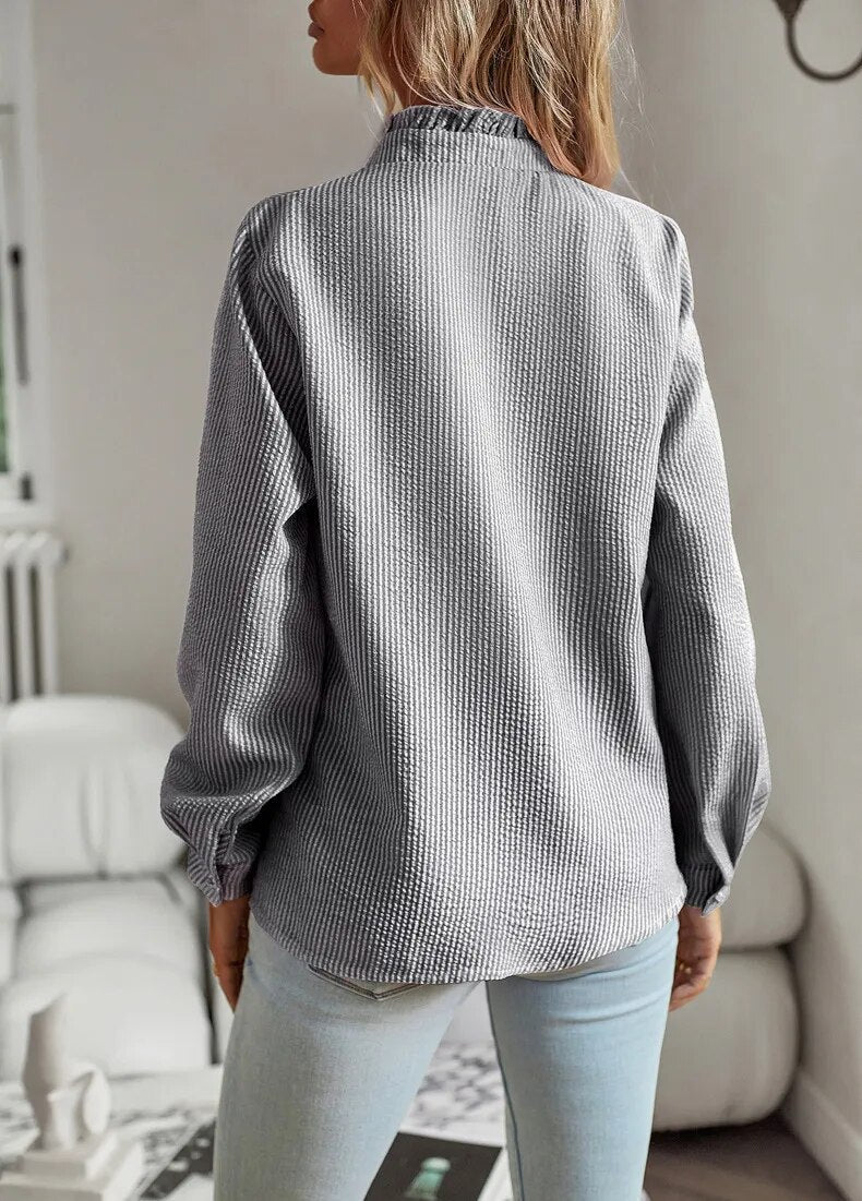 Elegant long-sleeved women's blouse with stand-up collar